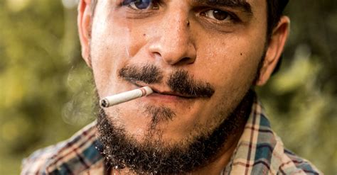 Portrait Of A Man Smoking A Cigarette · Free Stock Photo