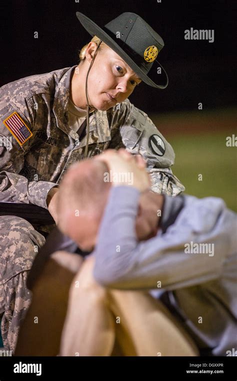 a female drill sergeant instructor monitors a drill sergeant candidate at the us army drill