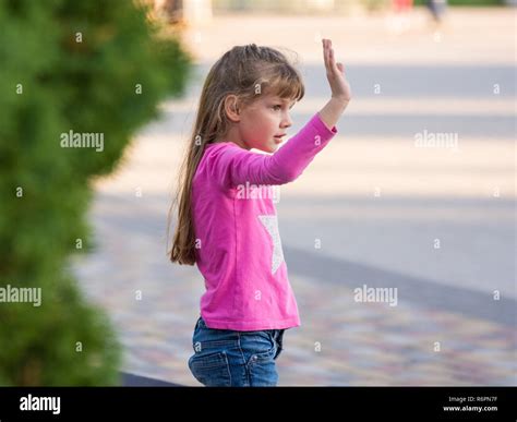 Six Year Old Girl Waving His Hand Side View Stock Photo Alamy