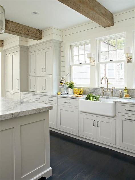 Not all country styled kitchens are painted white this farmhouse. Light Gray KItchen with Rustic Wood Ceiling Beams ...