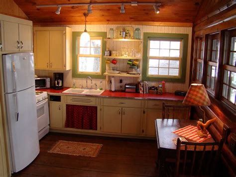Vintage interior design of kitchen space with small wooden table against eucalyptus wall with simple chair, food and kitchen accessories. Vintage Log Cabin Retro Custom Cabinetry Kitchen | Cabin interior design, Log cabin interior ...