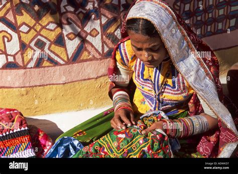 Tribal Woman Doing Embroidery Outside Her Home In The Village Of Ludia