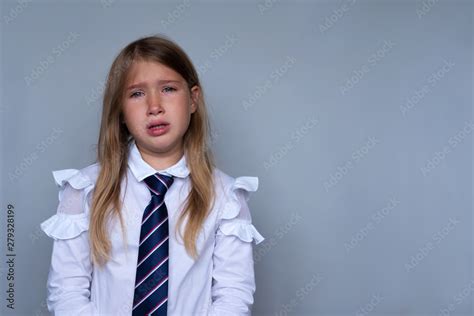 small schoolgirl covering face crying portrait preteen stressed