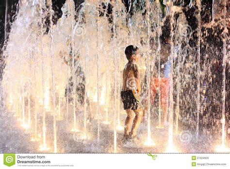 Playing in the water fountain by waiai, released 16 july 2017. Kids Playing In Water Fountain At Night Editorial Stock ...