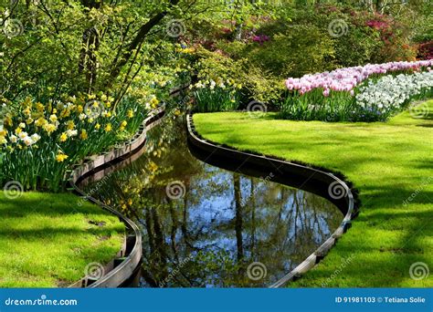 Colorful River Landscape With Flowers In Spring Dutch Garden Keukenhof