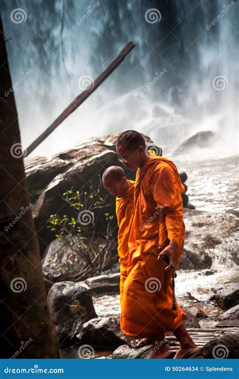 Pensive Buddhist Monks Walking Around Waterfall Editorial Stock Image