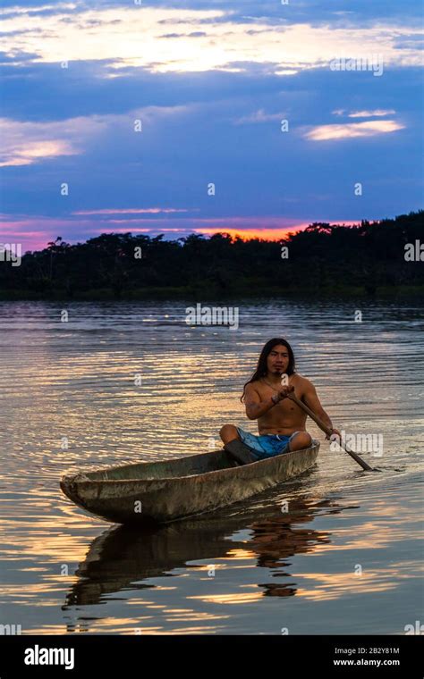 primitive adult man with boat on pond grande cuyabeno national park ecuador at sunset model