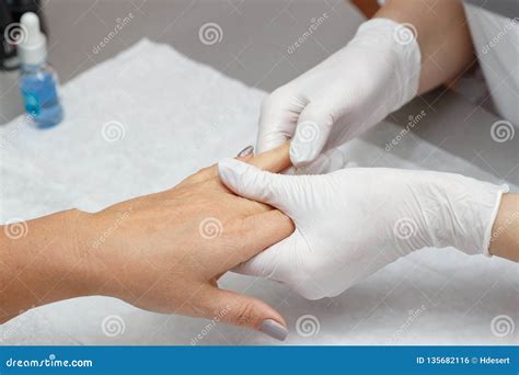 Massage Therapist Massaging Hands Of A Woman In A Beauty Salon Stock