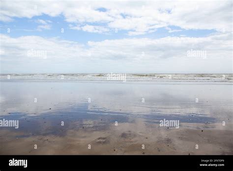 Blue Sky And Clouds Reflected In The Wet Sand Stock Photo Alamy
