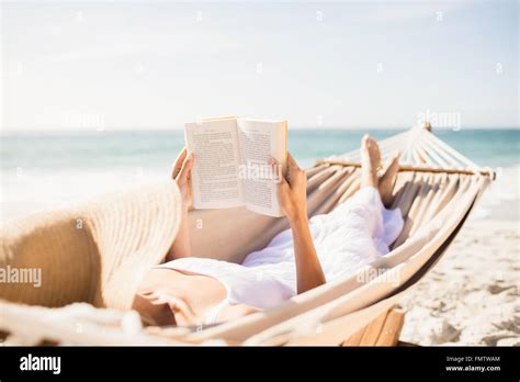 Woman Reading Book In Hammock Stock Photo Alamy