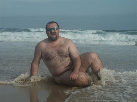 Fat Hairy Chested Bear In Shades Poses Nude In Wet Sand On