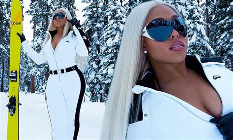 jordyn woods is a sexy snow bunny in plunging white winterwear as she poses in icy forest