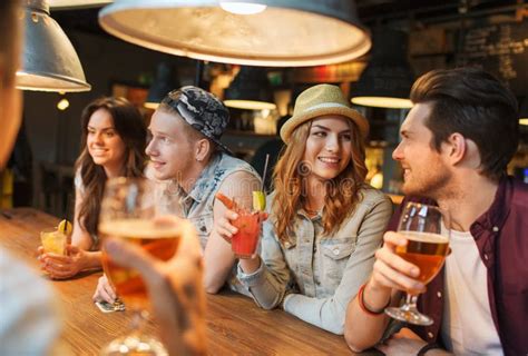 Happy Friends With Drinks Talking At Bar Or Pub Stock Image Image Of