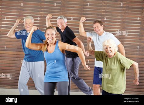 Happy Group Of Seniors Dancing Together In The Fitness Center Stock