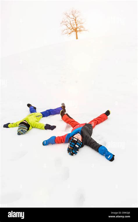 Two Boys Making Snow Angels Stock Photo Alamy