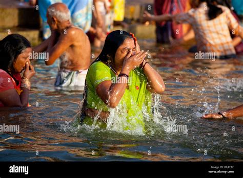 Hindu Woman Bathing In The Ganges River In Varanasi India Stock Photo