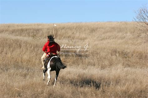 A Native American Sioux Indian Man Riding Horseback Away On A Indina