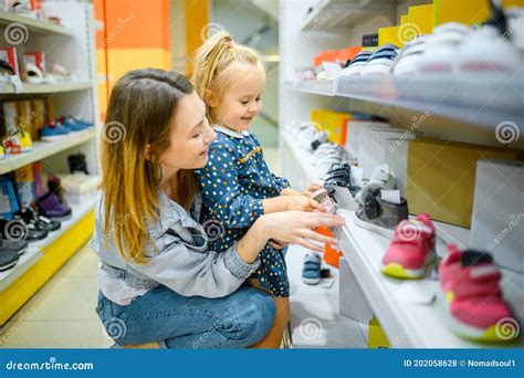 Mother And Baby Looking On Shoes In Kid S Store Stock Photo Image Of