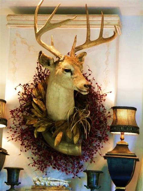 Woman wearing antler deer headband looking at decorated christmas tree. Deer Head with Wreath | Deer head decor, Christmas decorations rustic, Deer decor