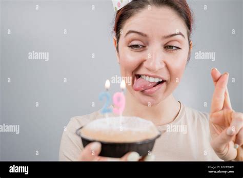 Happy Caucasian Woman Sticking Out Her Tongue And Blowing Out The
