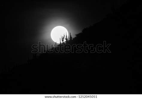 Full Moon Setting Behind Mountain Ridge Stock Photo 1252045051