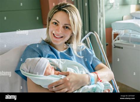 Mother With Her Newborn Baby At The Hospital A Day After A Natural