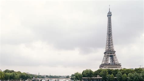 Eiffel Tower Paris On Side With Background Of Gray Clouds 4k Hd Travel