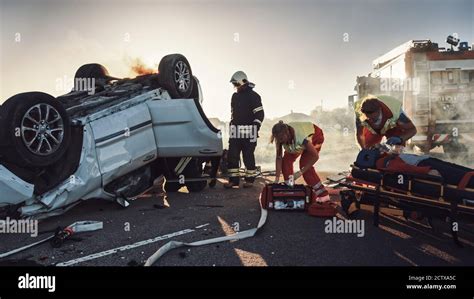 On The Car Crash Traffic Accident Paramedics And Firefighters Rescue
