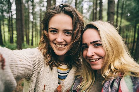 Two Teenage Girls Taking A Selfie In Woodland Del Colaborador De