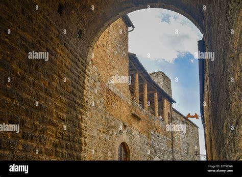 arched passage under the torre grossa the tallest tower in san gimignano 54 m with the