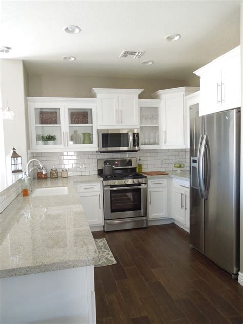 Dark wood kitchen flooring already looks pretty vintage all on its own. Next house...white cabinets, white backsplash, gray ...