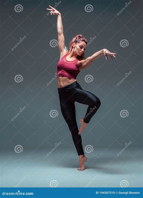 Pretty Young Female Dancer Dancing Barefoot Isolated On Gray Background
