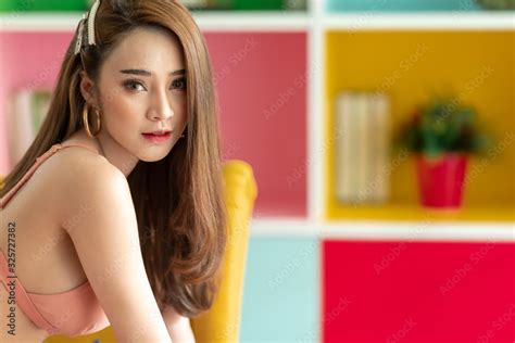 Cute Asian Woman Sitting On Yellow Arm Chair Cute Smle With Copy Space For Seductive
