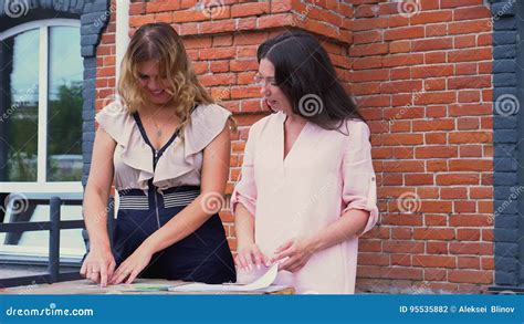 Deux Femmes Discutent Des échantillons De Tissus Au Bureau Sur Un