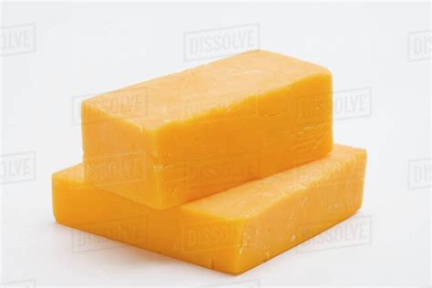 Two Pieces Of Cheddar Cheese Stock Photo Dissolve