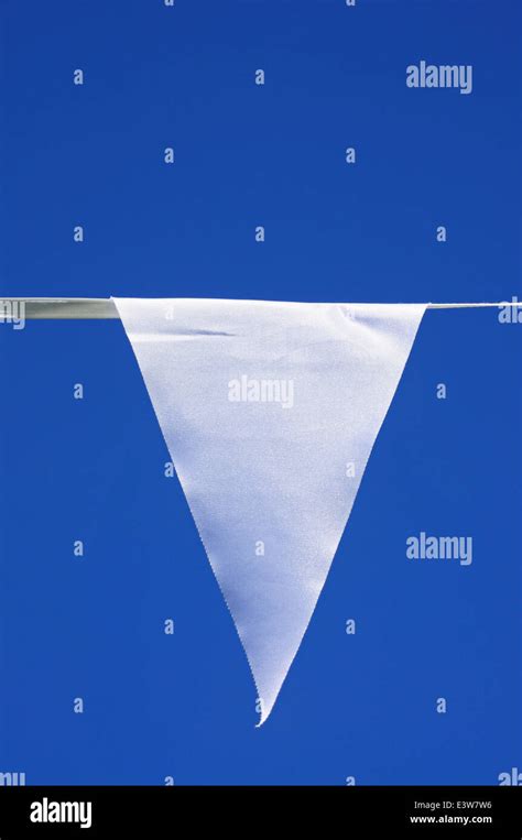 White Triangular Flag Banner With Copy Space Against A Blue Background
