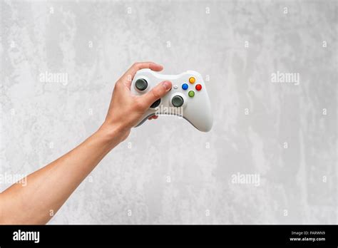 Hand Holding Gamepad On Grey Concrete Background Man With Controller