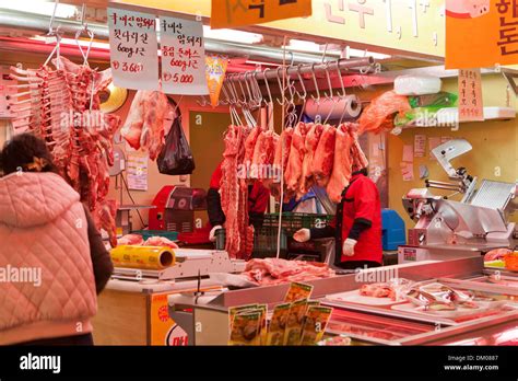 Cuts Of Meat Hanging On Hooks At A Traditional Market Butcher Shop