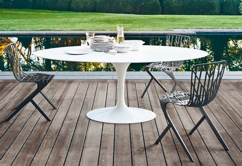 Lighting can make or break your commercial outdoor patio. Saarinen Tulip outdoor dining table by Knoll | STYLEPARK