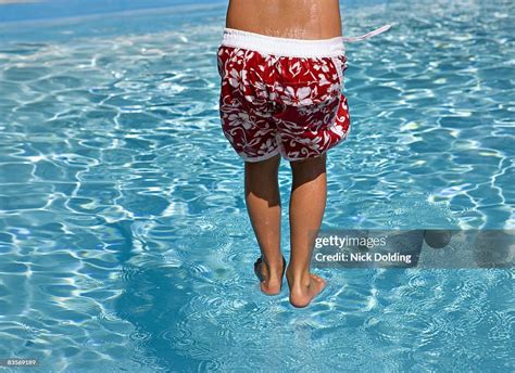 Boy Jumping Into Swimming Pool High Res Stock Photo Getty Images