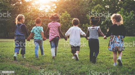 Kids Holding Hands Together Walking In The Park Stock Photo Download