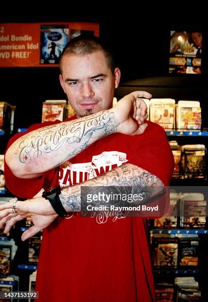 Rapper Paul Wall Shows Off His Tattoos While Posing For Photos At