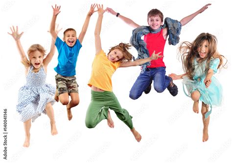 Group Of Happy Cheerful Sportive Children Jumping And Dancing Stock