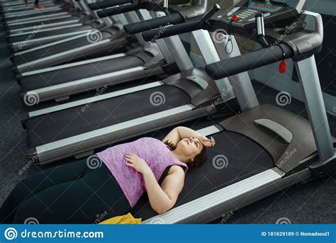 Tired Overweight Woman Lying On Treadmill In Gym Stock Image Image Of