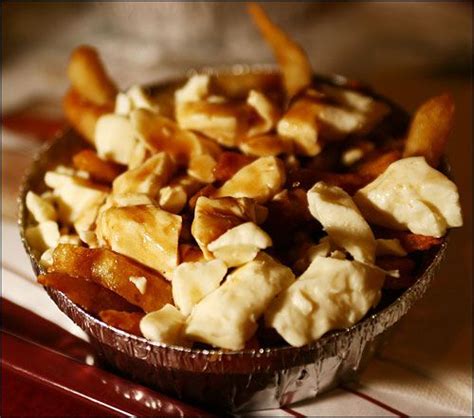 French Fries Topped With Cheese Curds And Covered With Brown Gravy
