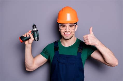 Premium Photo Portrait Of Handsome Man Repairer Successful Handyman Hold Perforator Show Thumb