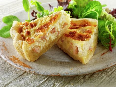 Two Pieces Of Quiche Lorraine With Salad Leaves Stock Photo Dissolve