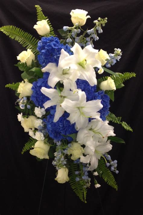 Use blue casket flowers and thousands of other assets to build an immersive game or experience. Blue and white Funeral Standing Spray. Visit us at www ...