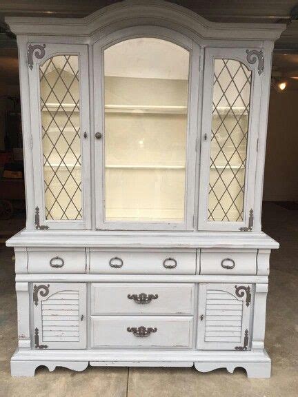 38 wide x 18 deep x 69 high to the top of the decorative piece. China cabinet, antique white inside, slate grey outside ...