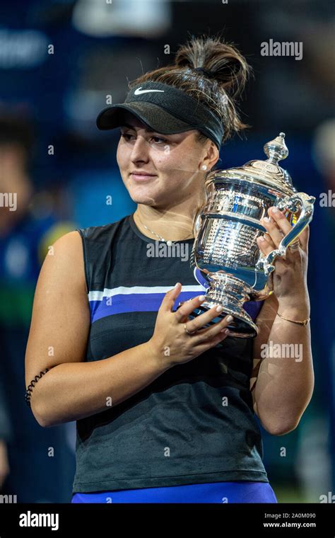 bianca andreescu of canada holding the championship trophy after defeating serena williams and